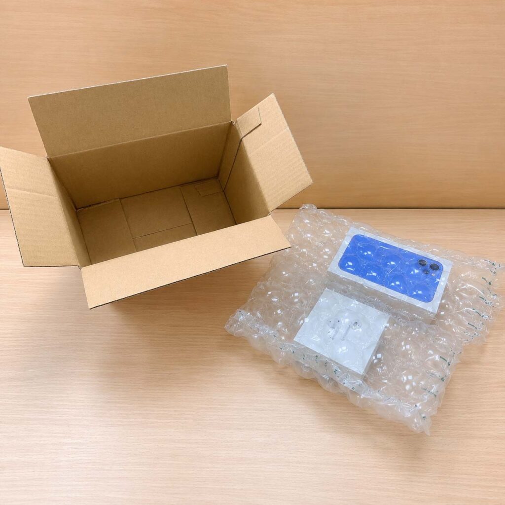 葫蘆型膠膜包覆手機與耳機商品的出貨示意，適合小型電商與蝦皮賣家使用的手動充氣包材與緩衝包材，不用機器充氣也能提供完整防護